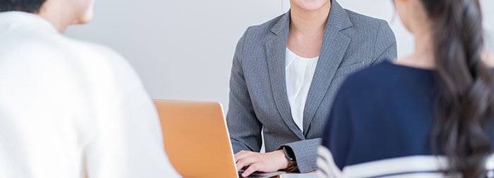 専門家の女性に相談する若い夫婦